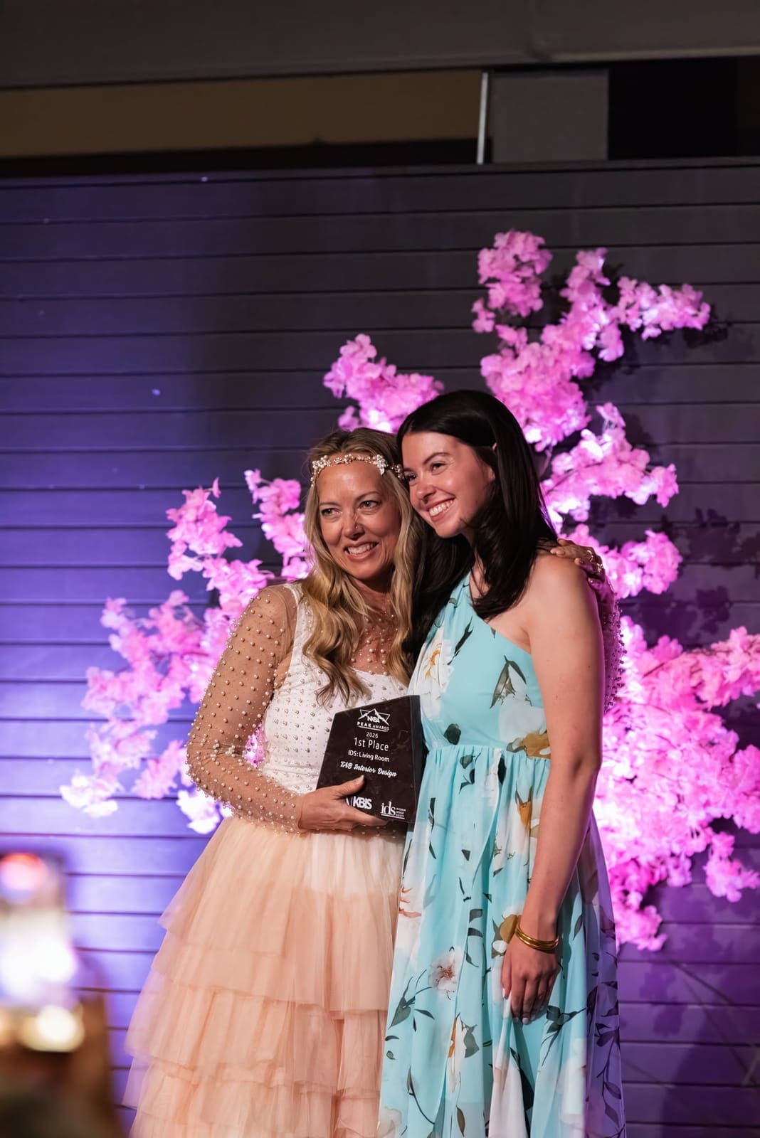Trish Bonney and Gabby Hinchey holding their 2026 NKBA Peak Awards first-place trophy